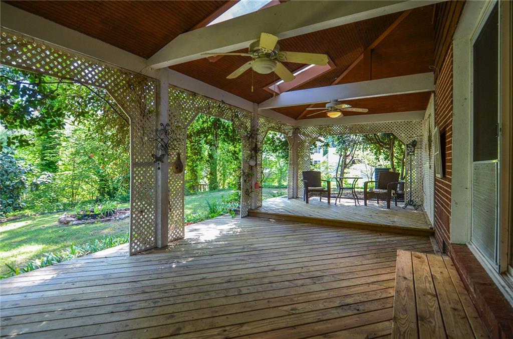 716 Killian Hill Road Southwest Lilburn, GA 30047 - Photo 51 of 56 a view of a patio with table and chairs under an umbrella with wooden floor
