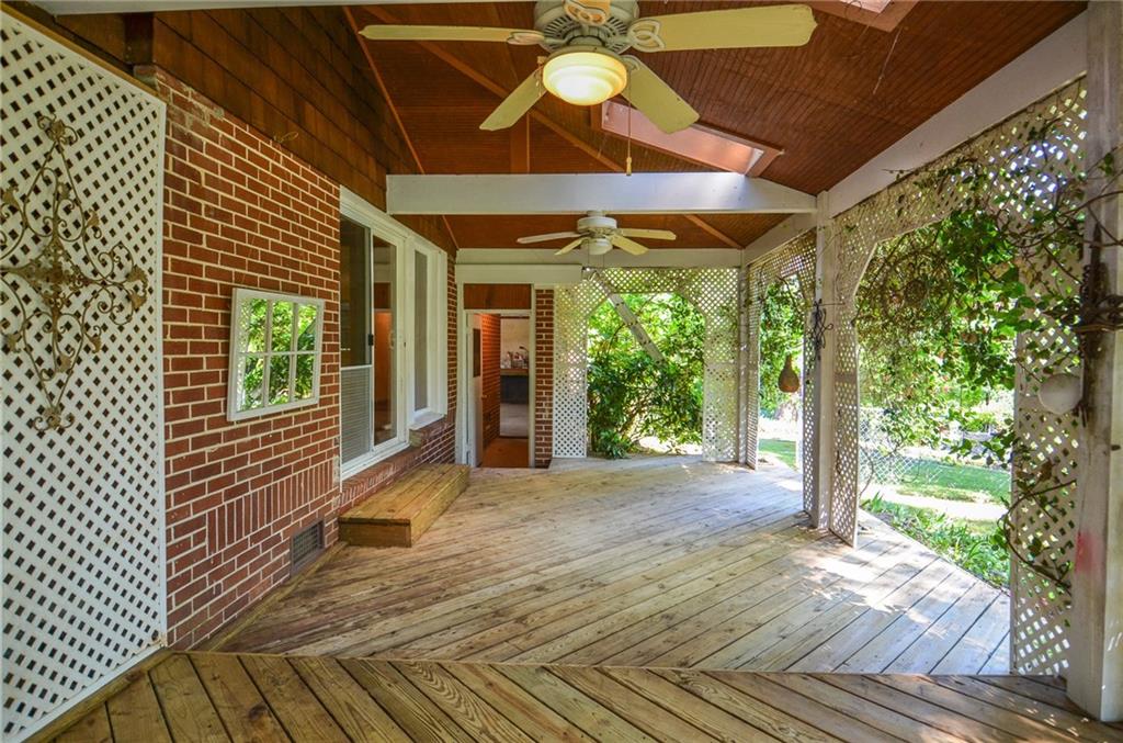 716 Killian Hill Road Southwest Lilburn, GA 30047 - Photo 54 of 56 a view of a porch with wooden floor and fence