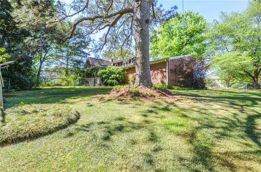 716 Killian Hill Road Southwest Lilburn, GA 30047 - Photo 56 of 56 a view of a yard with plants and large trees