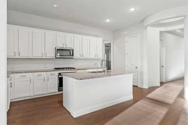 a view of a room with a ceiling fan and window