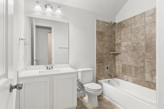 an empty room with a window and ceiling fan