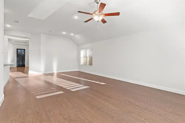 a view of kitchen and empty room with kitchen view