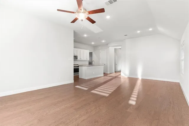a kitchen with sink stove and cabinets