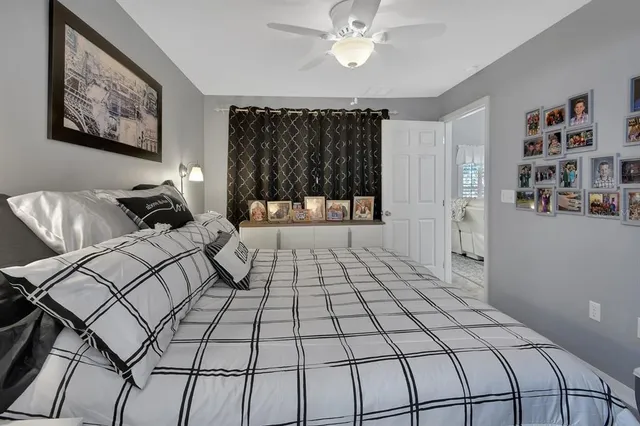 a bedroom with a bed and a painting on the wall