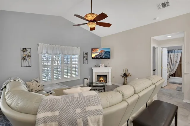 a living room with furniture a fireplace and a window