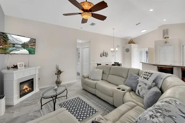 a living room with furniture a fireplace and a flat screen tv