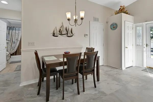 a view of a dining room with furniture and chandelier
