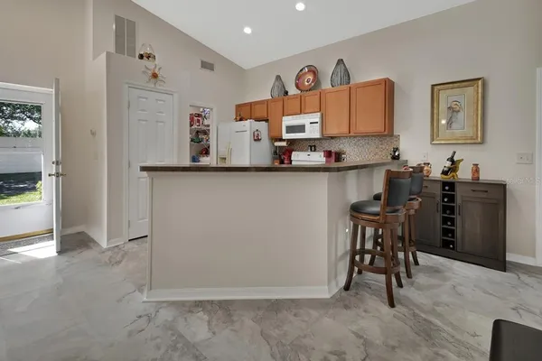 a view of kitchen with furniture and wooden floor