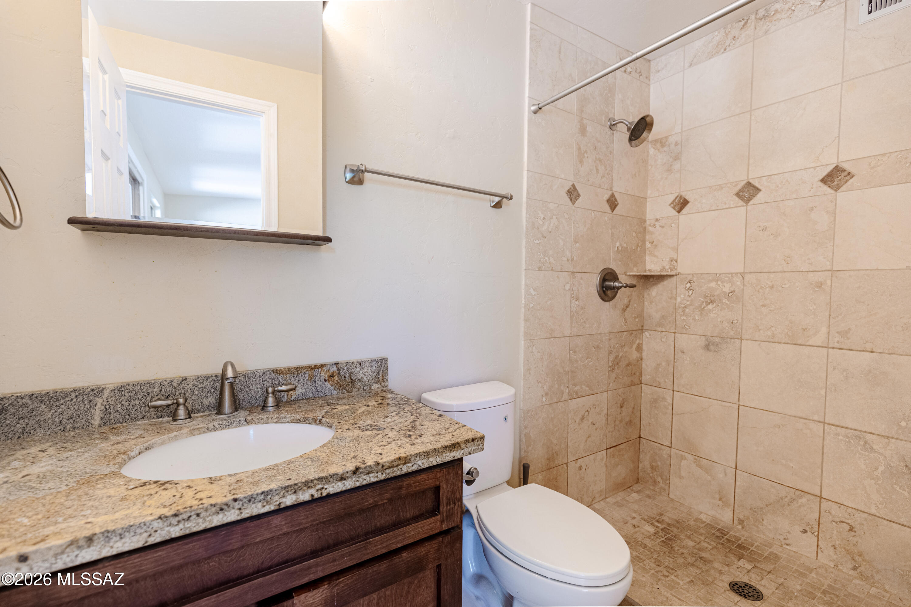 545 East Rancho Catalina Place Tucson, AZ 85704 - Photo 11 of 13 a bathroom with a granite countertop toilet sink and mirror