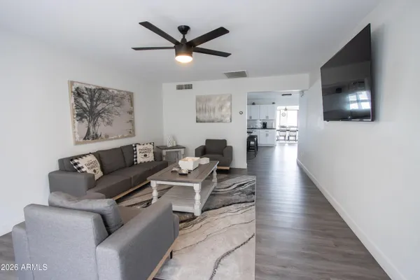 a living room with furniture and a flat screen tv
