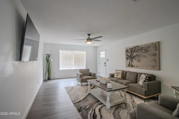a living room with furniture and wooden floor