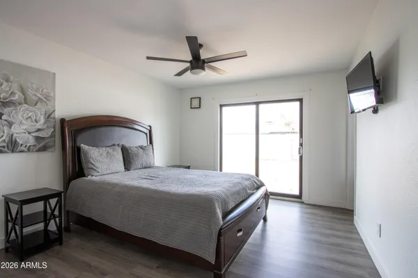 a bedroom with a bed and a flat screen tv