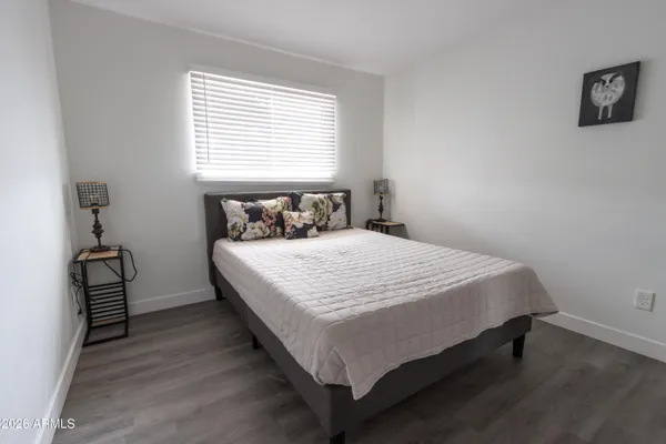 a large bed sitting in a bedroom next to a window