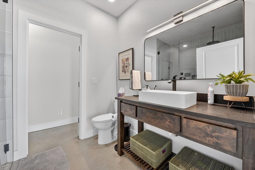 9082 Wolf Run Krum, TX 76249 - Photo 16 of 38 a bathroom with a sink a toilet and a mirror