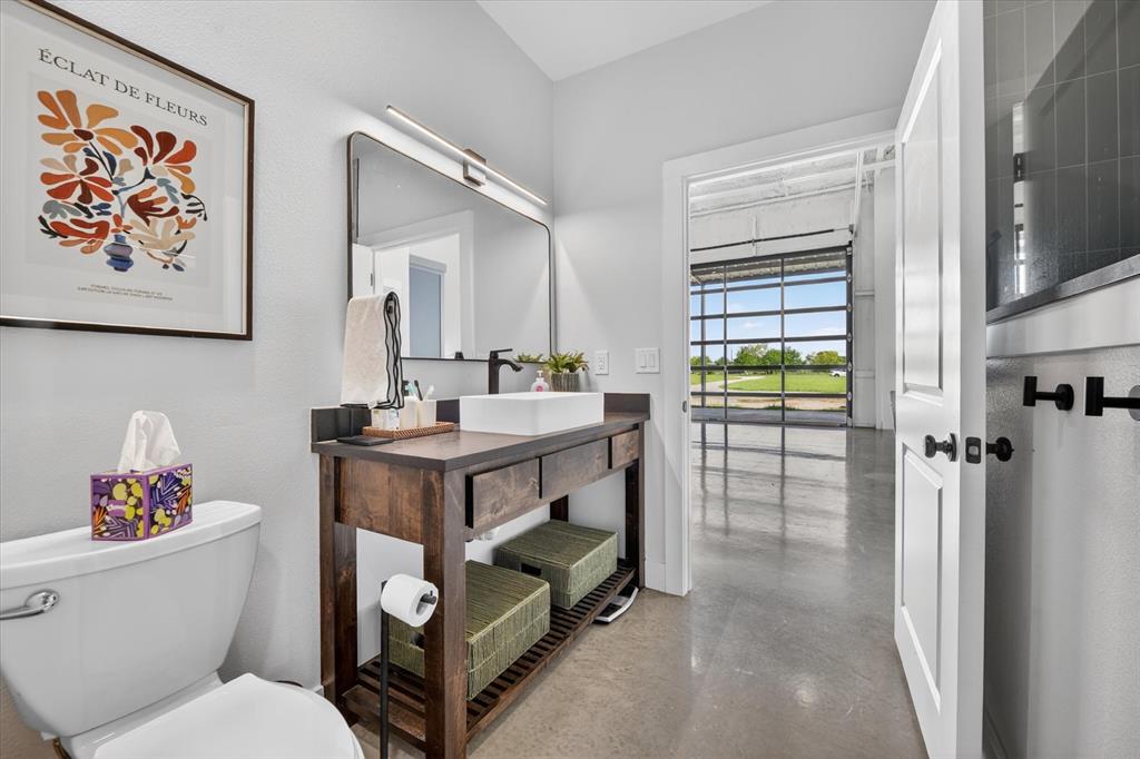 9082 Wolf Run Krum, TX 76249 - Photo 18 of 38 a bathroom with a toilet a sink and a mirror