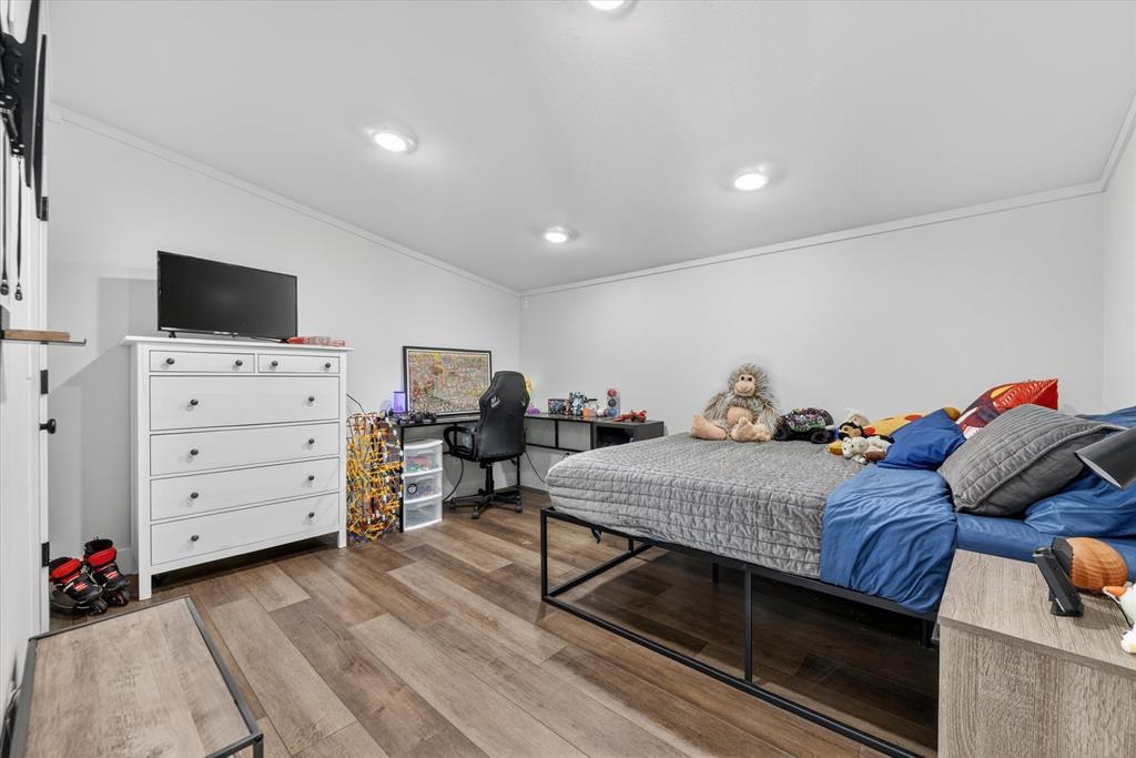 9082 Wolf Run Krum, TX 76249 - Photo 19 of 38 a bed room with a bed and furniture