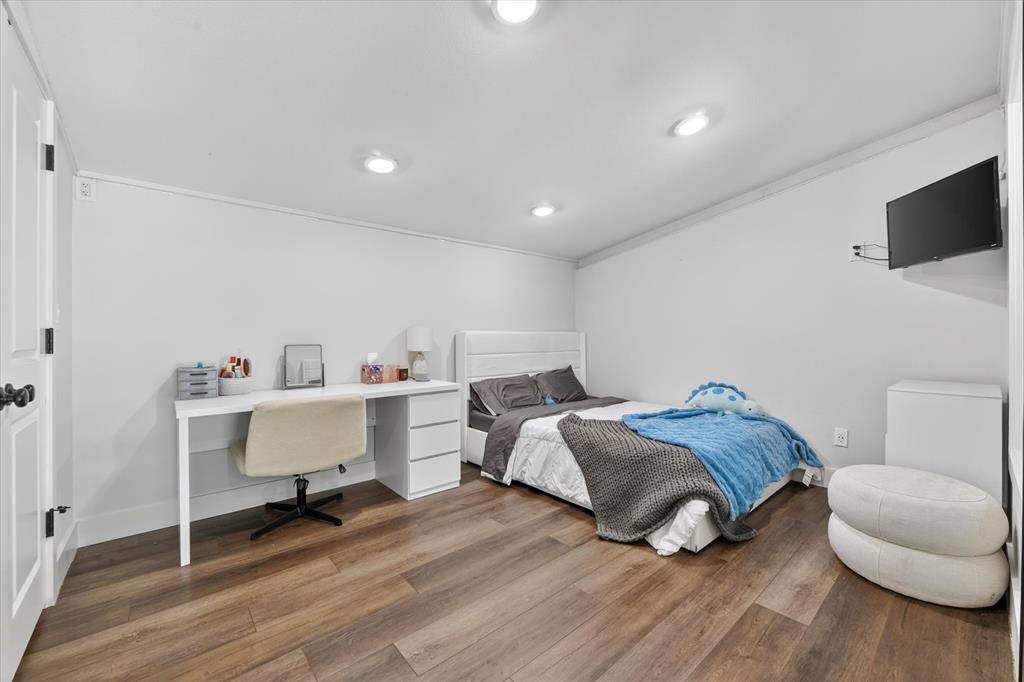 9082 Wolf Run Krum, TX 76249 - Photo 23 of 38 a spacious bedroom with a bed and a flat screen tv