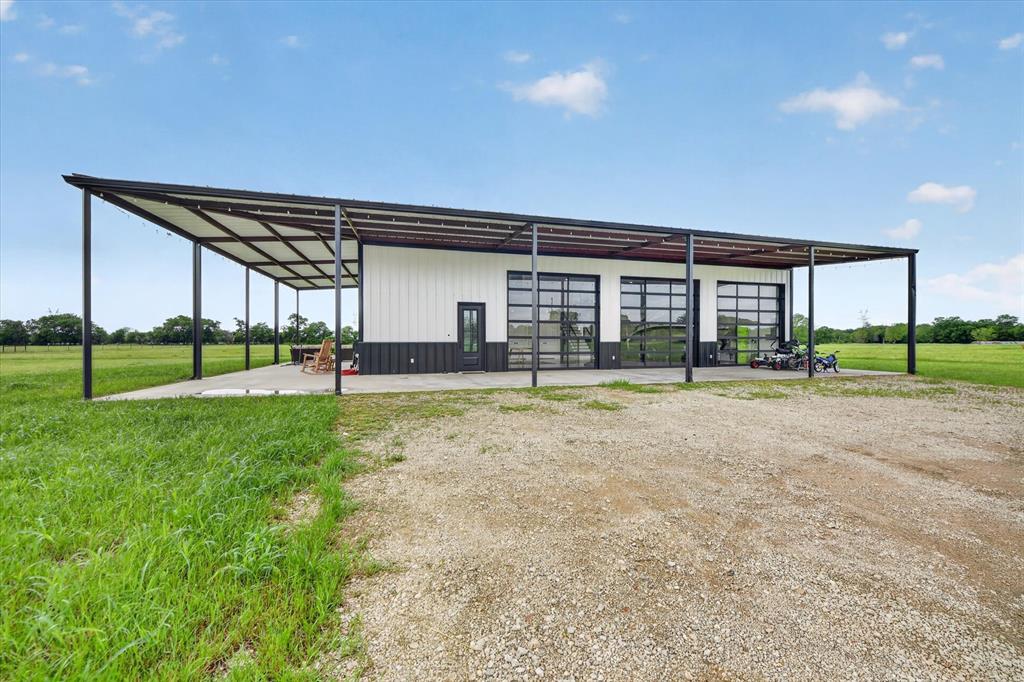 9082 Wolf Run Krum, TX 76249 - Photo 3 of 38 a view of a house with a yard and plants