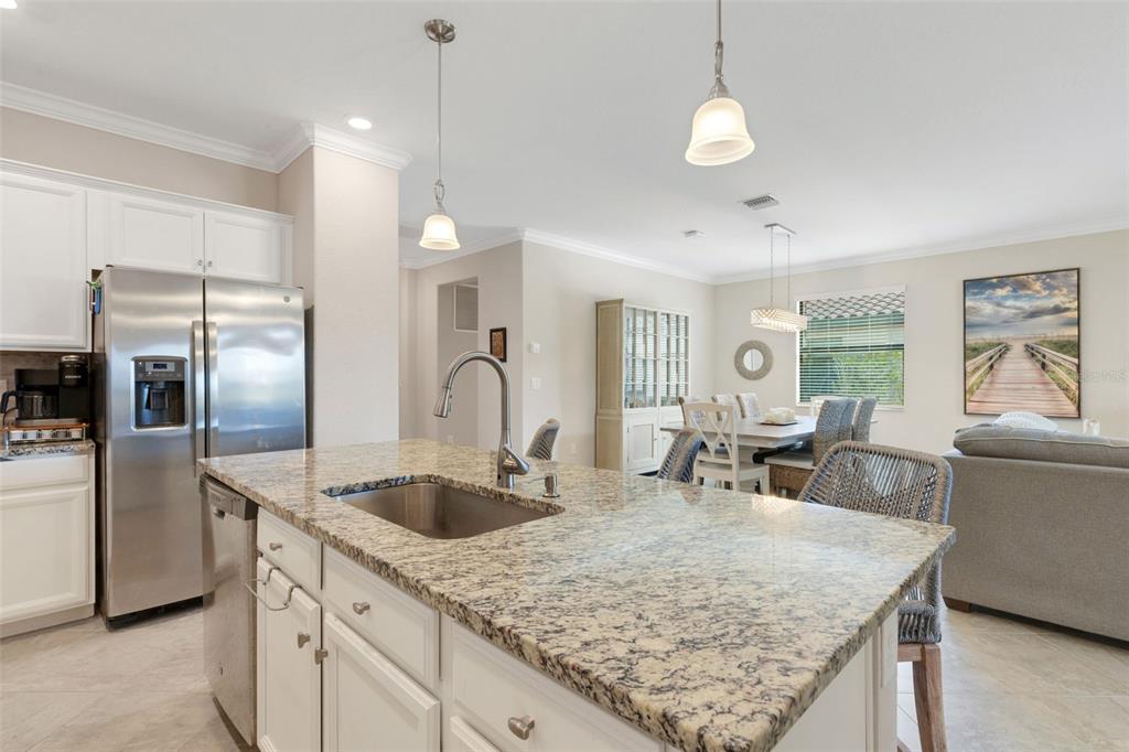 20573 Trattoria Loop Venice, FL 34293 - Photo 13 of 46 a kitchen with stainless steel appliances granite countertop a sink refrigerator and cabinets