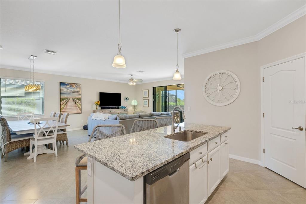 20573 Trattoria Loop Venice, FL 34293 - Photo 14 of 46 a living room with furniture a clock and a flat screen tv