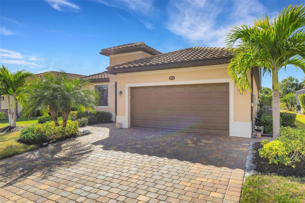 20573 Trattoria Loop Venice, FL 34293 - Photo 2 of 46 a front view of a house with a yard and garage