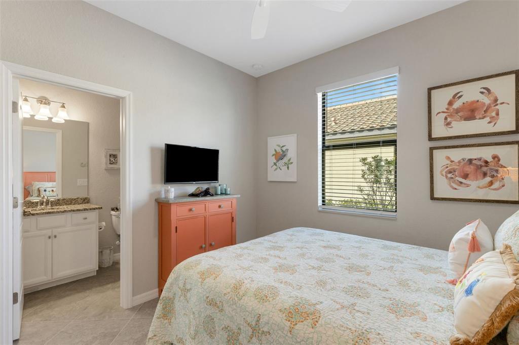 20573 Trattoria Loop Venice, FL 34293 - Photo 26 of 46 a bedroom with a large bed and a flat screen tv