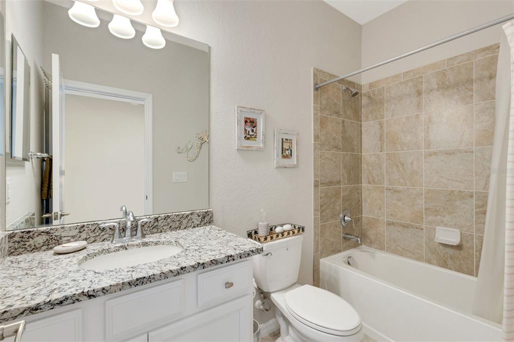 20573 Trattoria Loop Venice, FL 34293 - Photo 29 of 46 a bathroom with a granite countertop sink mirror toilet and bathtub