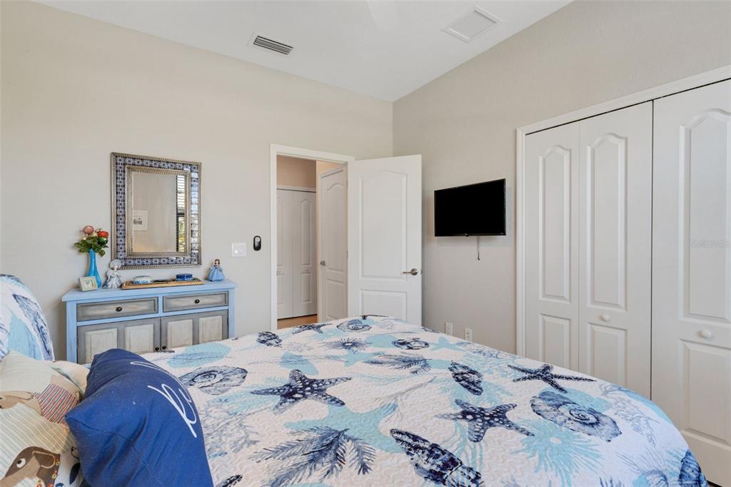20573 Trattoria Loop Venice, FL 34293 - Photo 33 of 46 a bedroom with a bed and a flat screen tv