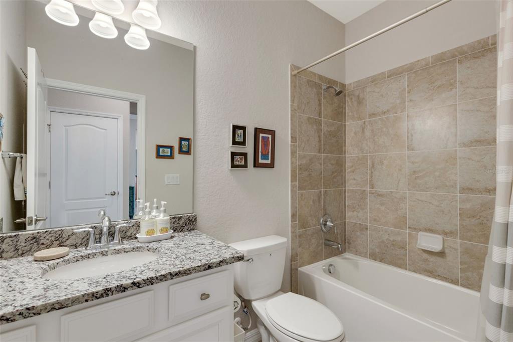 20573 Trattoria Loop Venice, FL 34293 - Photo 34 of 46 a bathroom with a granite countertop sink toilet mirror and bathtub