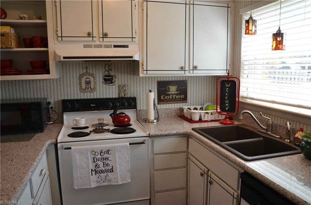 2235 Shadow Valley Road High Point, NC 27265 - Photo 3 of 18 Light and cherry kitchen has a larger window than most of these homes. Upgraded countertops and gorgeous sink!