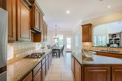 a kitchen with sink stove and cabinets
