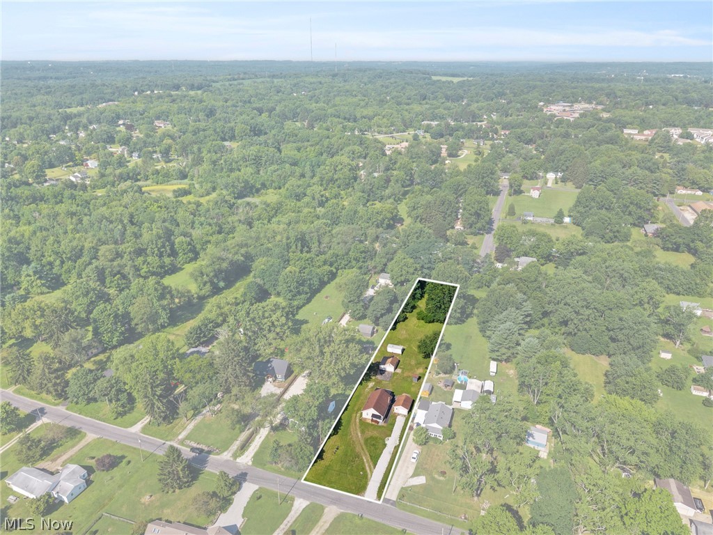 1218 Briggle Road Akron, OH 44320 - Photo 2 of 40 Expansive parcel featuring a main residence, an outbuilding, and a gravel driveway
