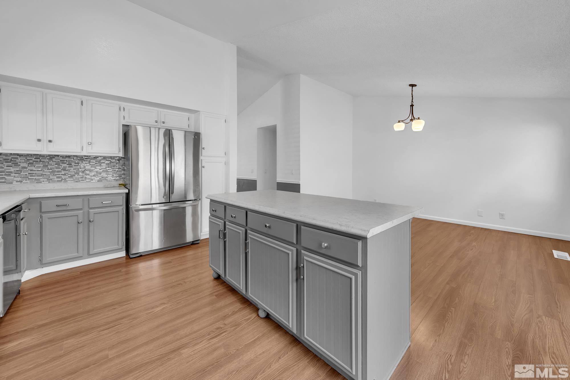 3805 Bexley Square Reno, NV 89503 - Photo 11 of 35 a kitchen with granite countertop a refrigerator and a stove top oven
