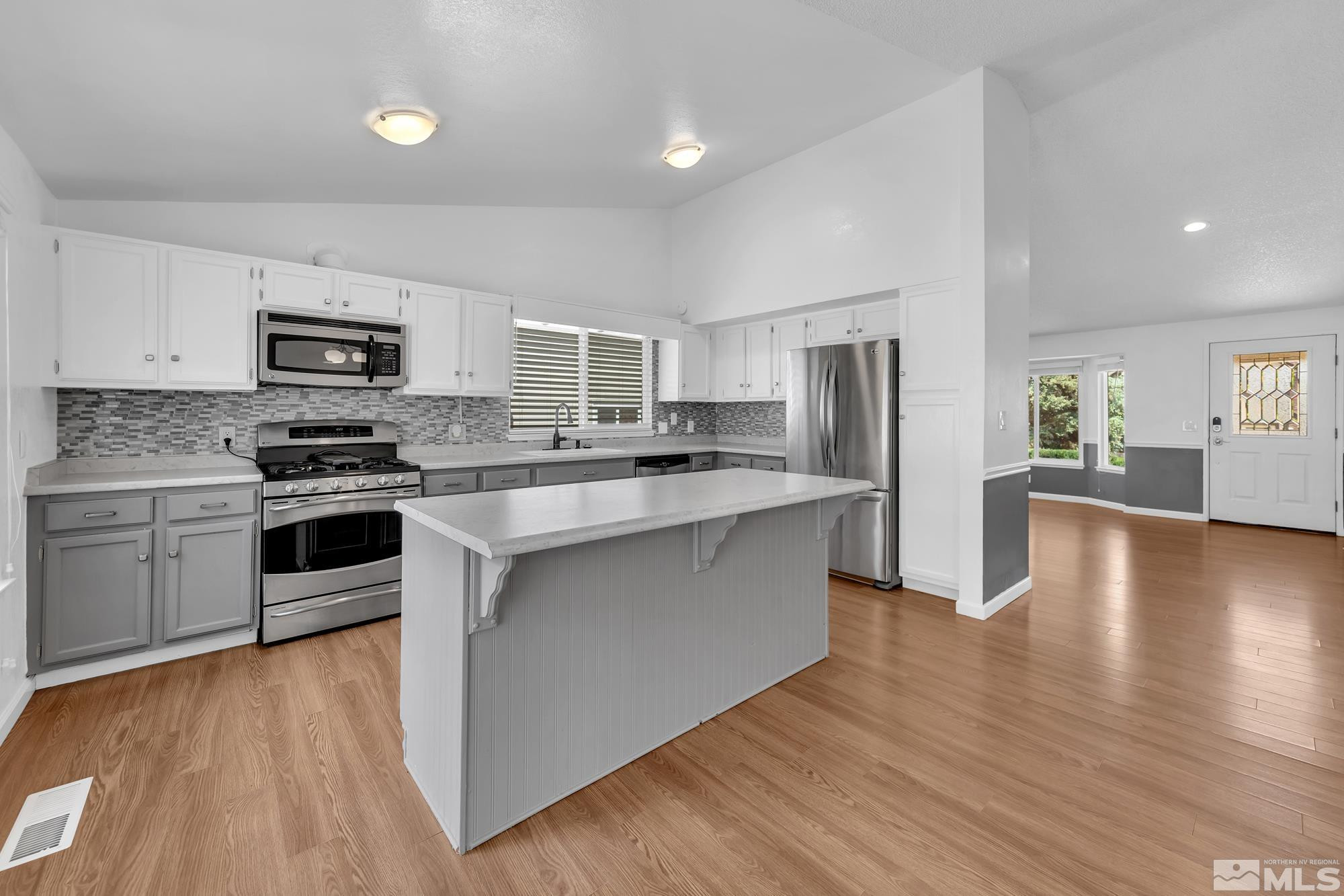 3805 Bexley Square Reno, NV 89503 - Photo 12 of 35 a kitchen with stainless steel appliances a stove top oven a sink and a refrigerator