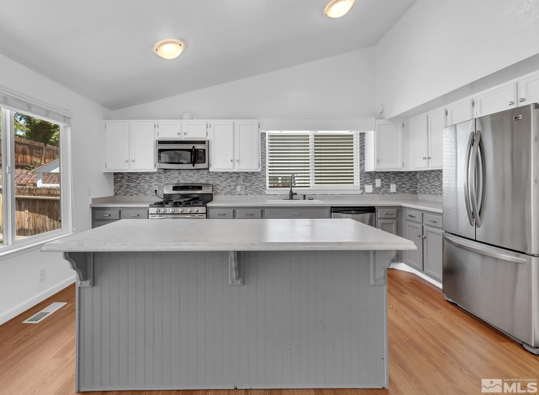 3805 Bexley Square Reno, NV 89503 - Photo 13 of 35 a kitchen with kitchen island a refrigerator stove and sink