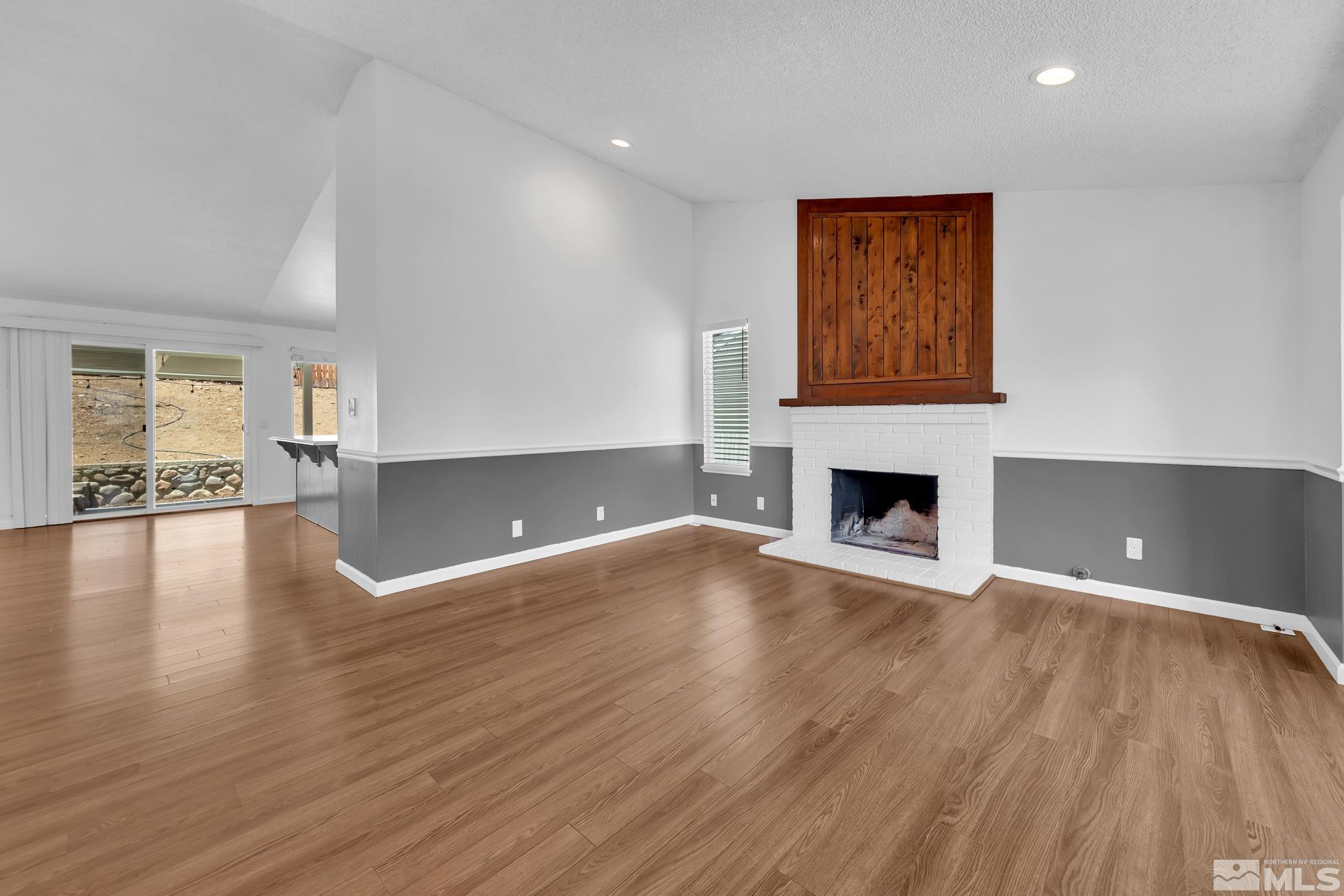 3805 Bexley Square Reno, NV 89503 - Photo 4 of 35 a view of a livingroom with wooden floor and a fireplace