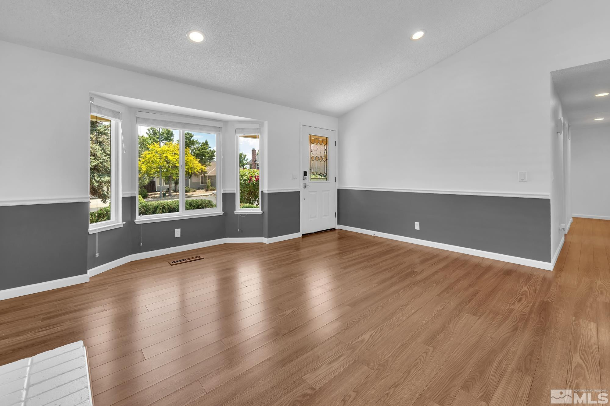 3805 Bexley Square Reno, NV 89503 - Photo 6 of 35 an empty room with wooden floor and windows