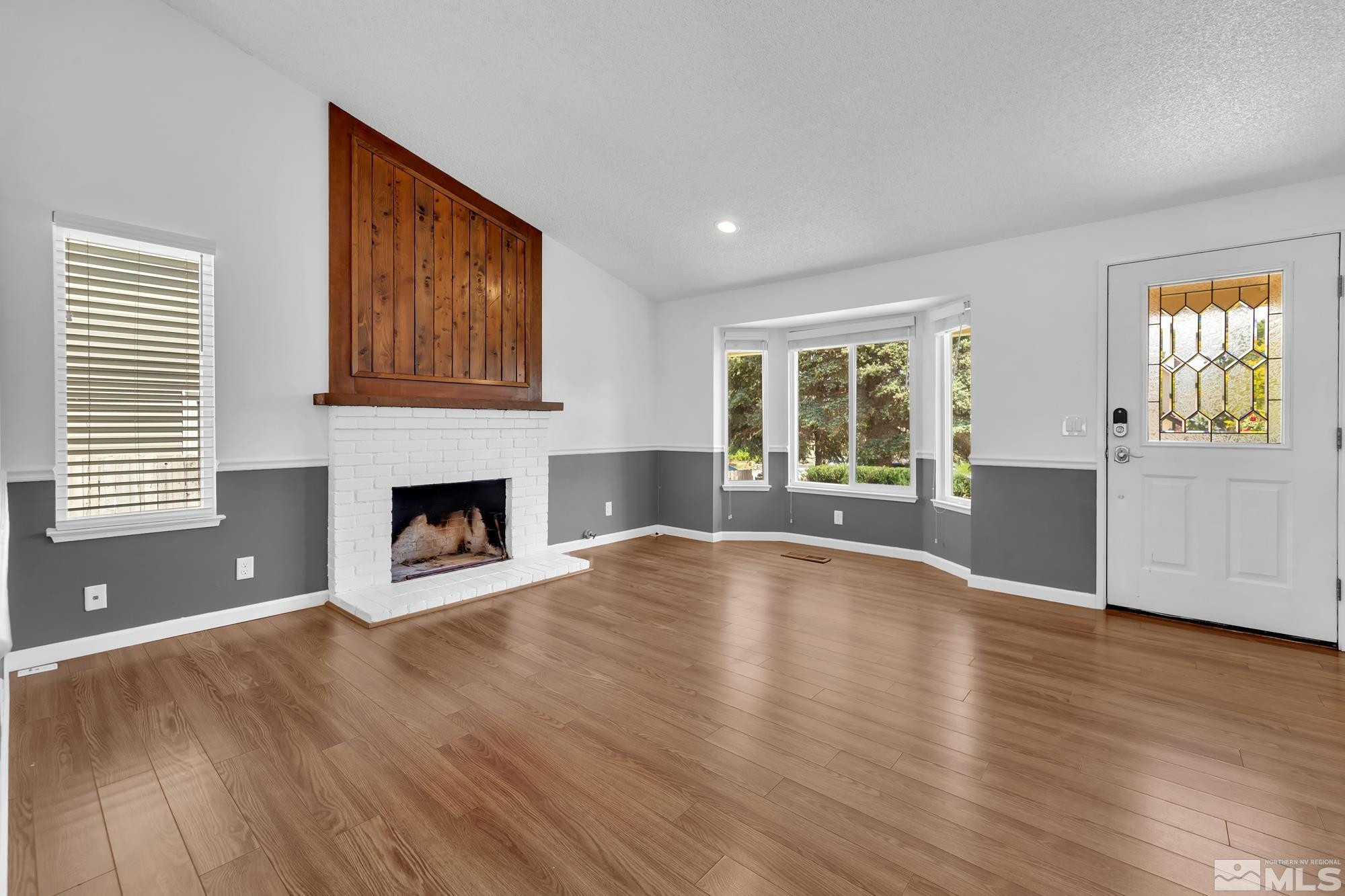 3805 Bexley Square Reno, NV 89503 - Photo 7 of 35 a view of empty room with wooden floor and fireplace