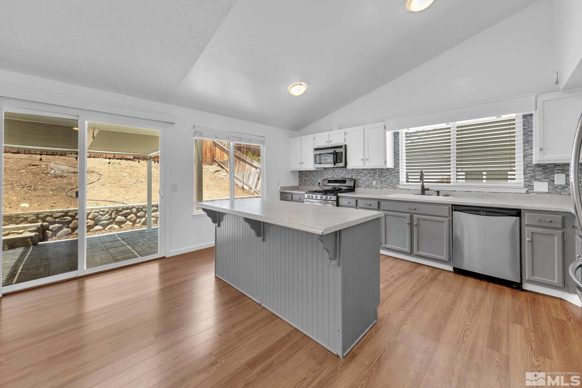 3805 Bexley Square Reno, NV 89503 - Photo 8 of 35 a kitchen with stainless steel appliances a sink cabinets and wooden floor