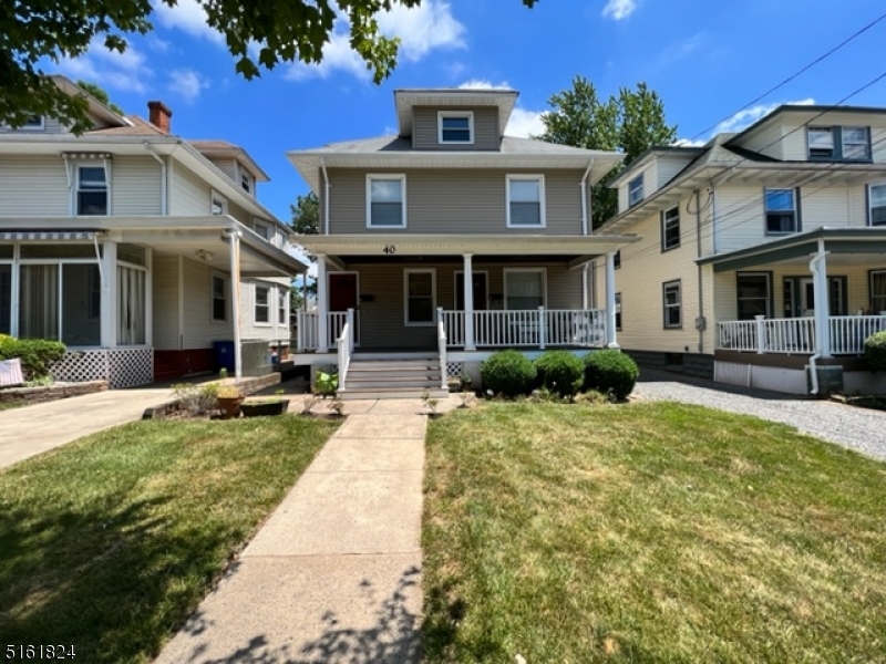 a front view of a house with yard patio and green space