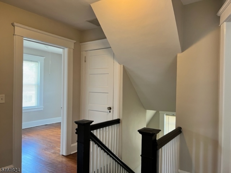 40 Codington Place Somerville, NJ 08876 - Photo 3 of 10 a view of a hallway with wooden floor and staircase