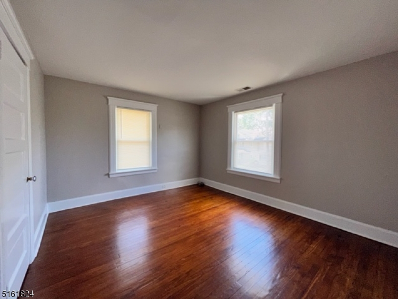 40 Codington Place Somerville, NJ 08876 - Photo 6 of 10 a view of an empty room with wooden floor and a window