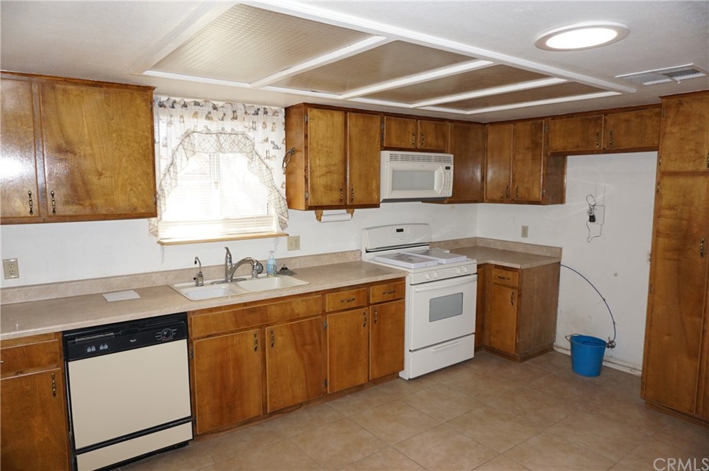 27841 Crestview Road Barstow, CA 92311 - Photo 13 of 28 a kitchen with a sink stove and cabinets