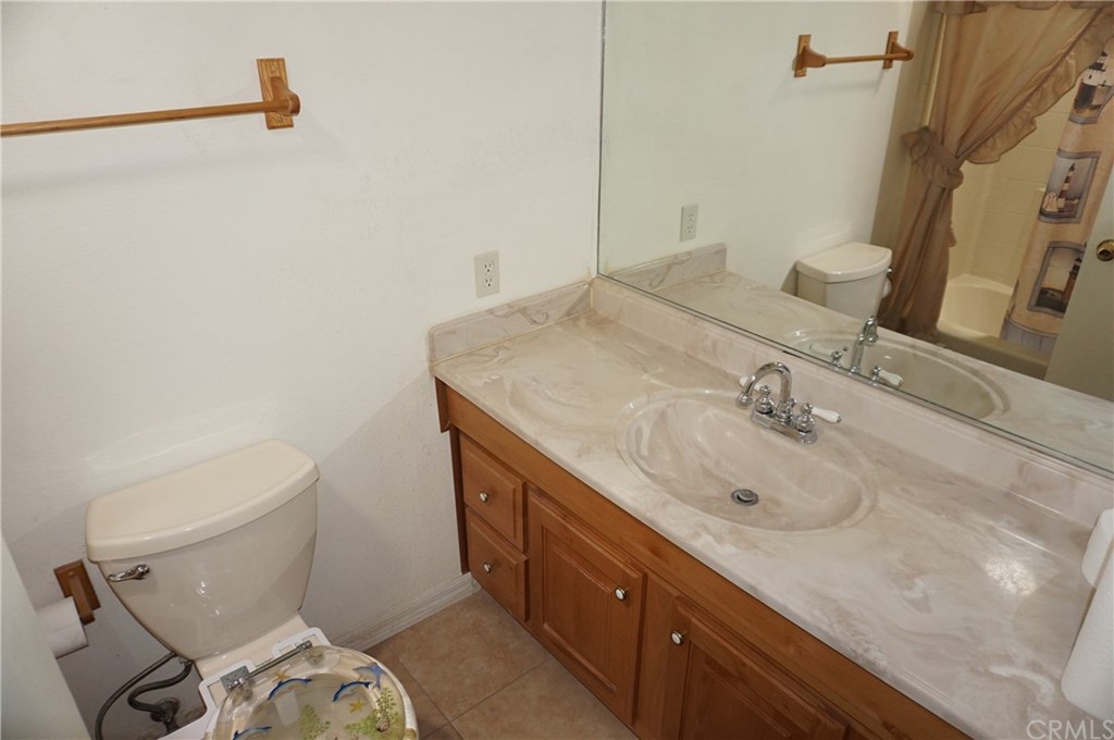 27841 Crestview Road Barstow, CA 92311 - Photo 18 of 28 a bathroom with a sink toilet and mirror