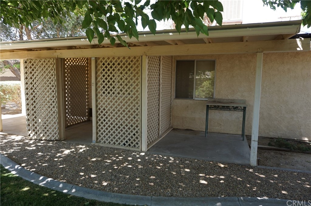 27841 Crestview Road Barstow, CA 92311 - Photo 25 of 28 a view of a brick house with a large window and an outdoor space