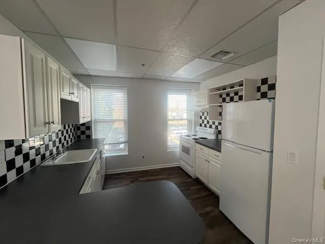 a kitchen with a refrigerator and a sink