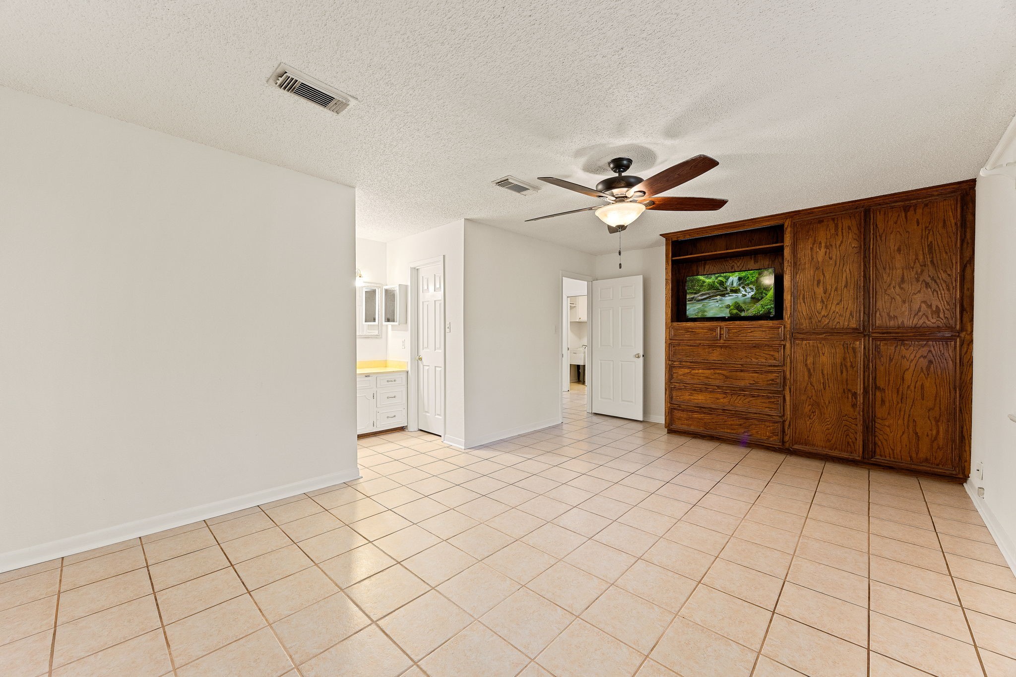 113 Hillendale Street Livingston, TX 77351 - Photo 22 of 47 Primary bedroom offering generous floor space and ensuite access.