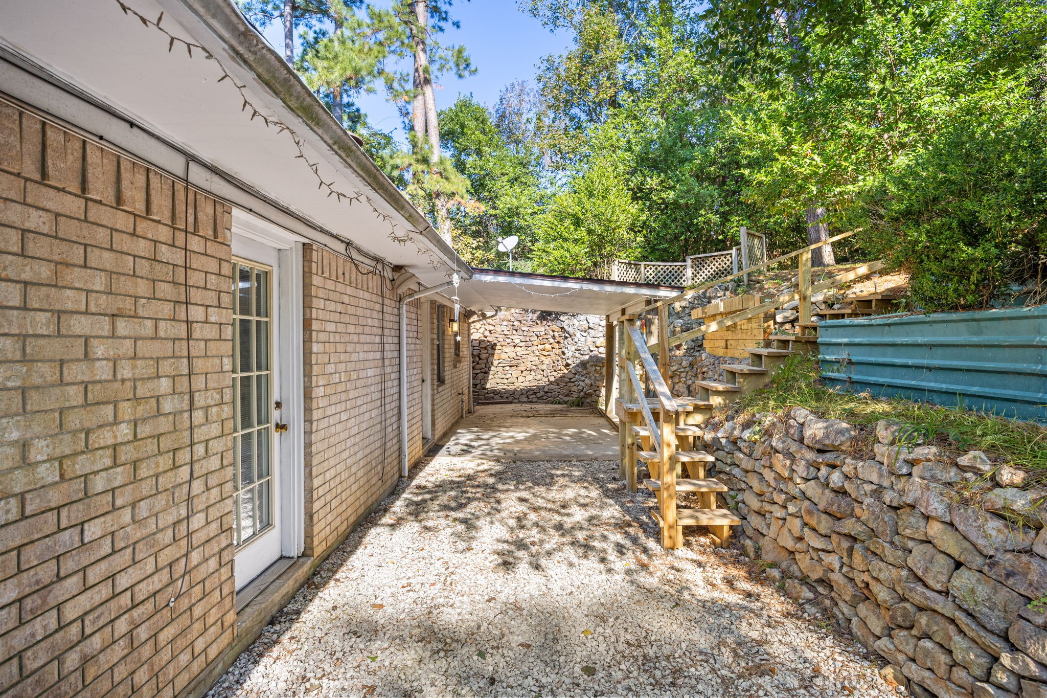 113 Hillendale Street Livingston, TX 77351 - Photo 32 of 47 Backyard pathway with terraced landscaping and private outdoor space.”