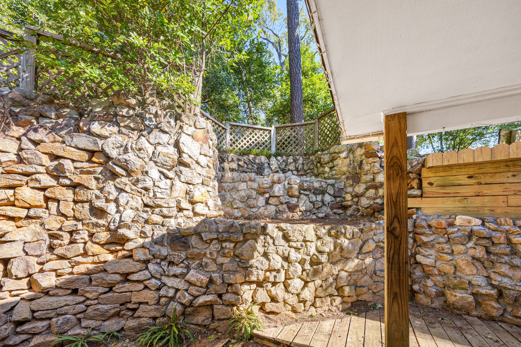 113 Hillendale Street Livingston, TX 77351 - Photo 33 of 47 Terraced stone landscaping offering a unique outdoor setting.