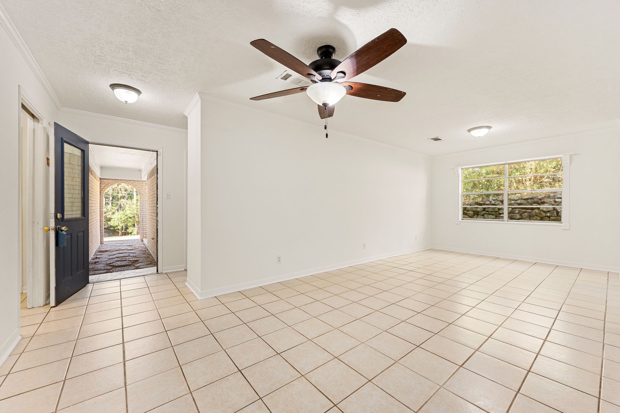 113 Hillendale Street Livingston, TX 77351 - Photo 6 of 47 Spacious front living area with an open layout and natural light.”